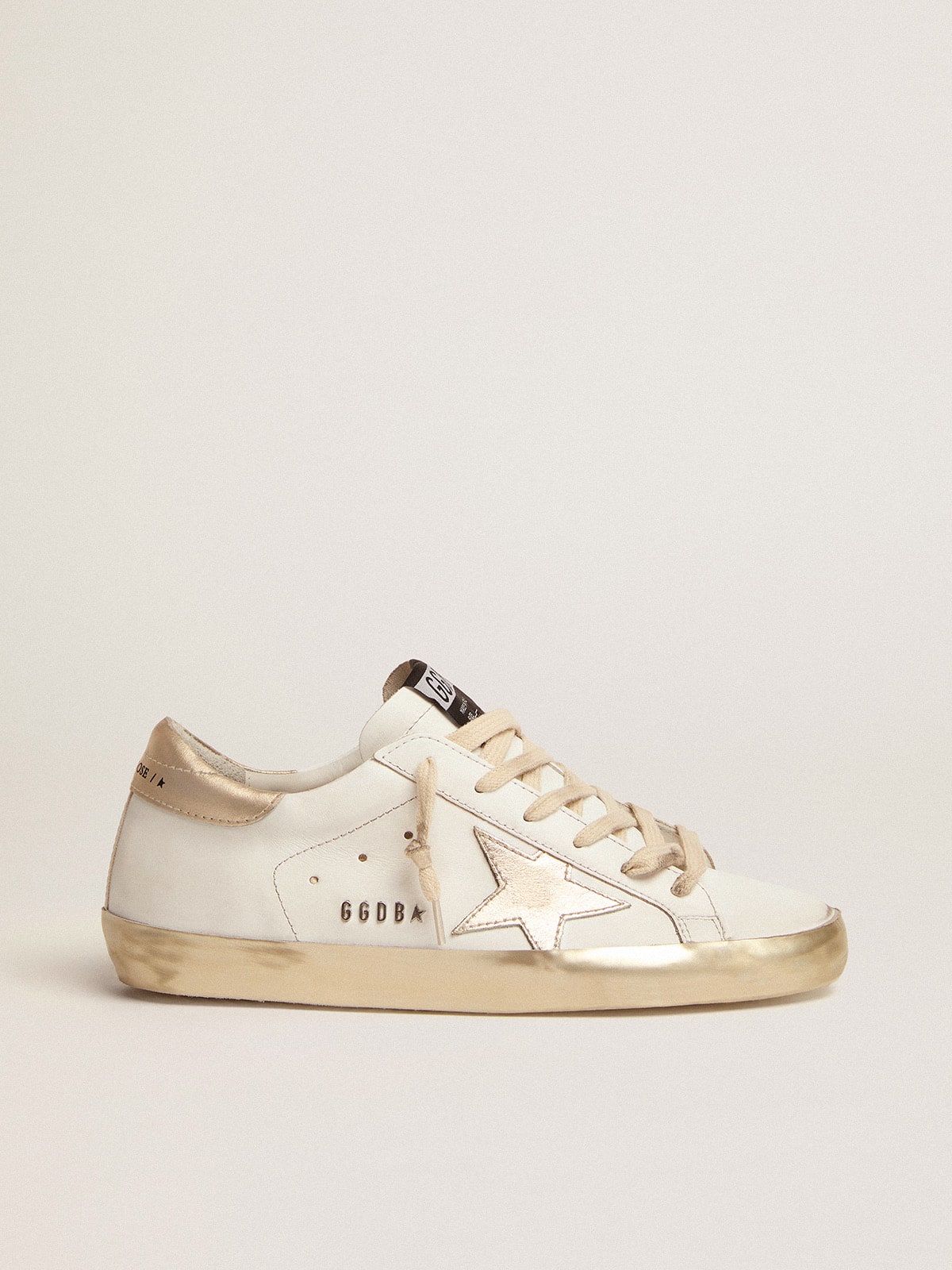 Women's Super-Star with gold sparkle foxing and metal stud lettering sneakers